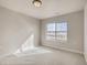 Bright bedroom featuring neutral carpet, paint and a large window with an open view at 917 W 129Th Pl, Denver, CO 80234