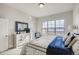 Bright bedroom features a large window, comfortable bed, and dresser at 917 W 129Th Pl, Denver, CO 80234