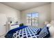 Comfortable bedroom with a bright window, adorned with stylish furniture and decor, creating a cozy atmosphere at 917 W 129Th Pl, Denver, CO 80234