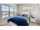 Bright bedroom featuring a large window offering neighborhood views, and complementing neutral walls and plush carpet at 917 W 129Th Pl, Denver, CO 80234