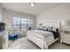 Bright bedroom features a large window, comfortable bed, and accent chair at 917 W 129Th Pl, Denver, CO 80234