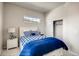 Bright bedroom featuring a comfortable bed with blue accents and a charming window, perfect for relaxation at 917 W 129Th Pl, Denver, CO 80234
