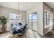 Bright dining area features a modern chandelier, round table, and sliding door to a balcony at 917 W 129Th Pl, Denver, CO 80234
