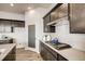 Stylish kitchen features sleek cabinetry, white countertops, stainless appliances, and herringbone tile backsplash at 917 W 129Th Pl, Denver, CO 80234