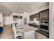 Modern kitchen with dark cabinets, white countertops, stainless steel appliances and large kitchen island at 917 W 129Th Pl, Denver, CO 80234