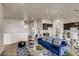 Bright living room with comfortable blue seating, modern decor, and easy access to kitchen at 917 W 129Th Pl, Denver, CO 80234