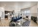 Open-concept living area features modern furnishings and seamless transition to the kitchen and dining areas at 917 W 129Th Pl, Denver, CO 80234