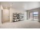 Bright and airy living room with an open layout, stylish shelving, and a sliding glass door for seamless indoor-outdoor living at 917 W 129Th Pl, Denver, CO 80234
