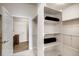 Bright walk-in closet with built-in shelving, and rods for optimal storage solutions and easy organization at 917 W 129Th Pl, Denver, CO 80234