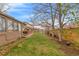 View of the backyard with a deck and a well-maintained lawn, perfect for outdoor activities at 2038 S Hoyt Way, Lakewood, CO 80227