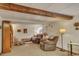Finished basement area with plush seating, beam, and natural light, offering a cozy space at 2038 S Hoyt Way, Lakewood, CO 80227