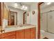 Bathroom showcasing a sink and vanity with wooden cabinets and a glass-enclosed shower at 2038 S Hoyt Way, Lakewood, CO 80227
