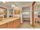Bathroom featuring double sinks and vanity, with a view into the main bedroom space at 2038 S Hoyt Way, Lakewood, CO 80227