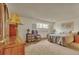 Spacious bedroom with a sitting area, large window, neutral carpet, and light-colored walls at 2038 S Hoyt Way, Lakewood, CO 80227