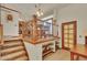 Charming breakfast nook with wood railing and view into the kitchen at 2038 S Hoyt Way, Lakewood, CO 80227