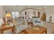 Comfortable living room with vaulted ceilings, neutral colors, and two beige armchairs at 2038 S Hoyt Way, Lakewood, CO 80227