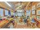 Large, wood-paneled workshop with ample workspace, natural light, and ceiling fan at 2038 S Hoyt Way, Lakewood, CO 80227