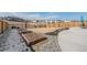 Landscaped backyard features a concrete patio, garden beds, and wood fence at 6664 Merrimack Dr, Castle Pines, CO 80108