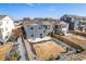 Backyard featuring a concrete patio with stairs leading to a two-story home, surrounded by a well-maintained lawn at 6664 Merrimack Dr, Castle Pines, CO 80108