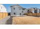 Expansive backyard features a concrete patio, staircase, and wood fence at 6664 Merrimack Dr, Castle Pines, CO 80108
