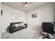 Bedroom with neutral walls features a black couch and desk at 6664 Merrimack Dr, Castle Pines, CO 80108