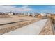 Picturesque neighborhood view with modern homes, sidewalks, and open space create a welcoming environment at 6664 Merrimack Dr, Castle Pines, CO 80108