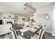 Open-concept dining room with modern light fixture and hardwood floors at 6664 Merrimack Dr, Castle Pines, CO 80108