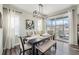Bright dining room with modern light fixture, neutral decor, and access to outdoor patio at 6664 Merrimack Dr, Castle Pines, CO 80108