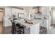Modern kitchen features white cabinets, stainless steel appliances, and a center island at 6664 Merrimack Dr, Castle Pines, CO 80108