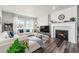 Inviting living room with a cozy fireplace, plush seating, and lots of natural light at 6664 Merrimack Dr, Castle Pines, CO 80108