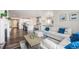 Open floor plan showing a connected living room, kitchen, and dining area with hardwood floors at 6664 Merrimack Dr, Castle Pines, CO 80108
