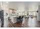 Open-concept living space boasts hardwood floors, an eat-in kitchen, and ample natural light at 6664 Merrimack Dr, Castle Pines, CO 80108