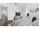 Bedroom with modern gray flooring, abundant natural light, and a television set against a white wall at 7220 S Gaylord St # G17, Littleton, CO 80122