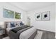 Bedroom showcasing a plush bed, natural light, artwork, and convenient closet access at 7220 S Gaylord St # G17, Littleton, CO 80122