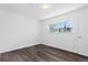 Bedroom with modern gray flooring and bright window overlooking trees at 7220 S Gaylord St # G17, Littleton, CO 80122
