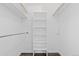 Walk-in closet with modern gray flooring and plenty of shelving for storage at 7220 S Gaylord St # G17, Littleton, CO 80122