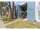 Exterior view of a two-story condo building with blue siding and well-maintained landscaping at 7220 S Gaylord St # G17, Littleton, CO 80122