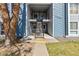 Two-story condo building with blue siding, stairs leading to upper units and street access at 7220 S Gaylord St # G17, Littleton, CO 80122
