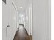 Hallway with wood-style floors, white walls, and closet space, creating a clean and functional transition at 7220 S Gaylord St # G17, Littleton, CO 80122