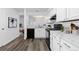 Modern kitchen boasts updated appliances, stylish backsplash, and wood flooring at 7220 S Gaylord St # G17, Littleton, CO 80122