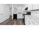 Modern kitchen with white cabinets, marble countertops, and stainless-steel appliances creating a bright and functional space at 7220 S Gaylord St # G17, Littleton, CO 80122