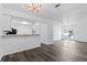 Open-concept home featuring a breakfast bar, modern lighting and sleek hardwood floors at 7220 S Gaylord St # G17, Littleton, CO 80122