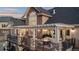 Elegant home exterior with a spacious deck featuring a fire pit and outdoor seating, perfect for entertaining and relaxation at 948 Buffalo Ridge Rd, Castle Pines, CO 80108