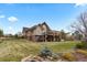 Stunning back exterior featuring a multi-level deck and patio, offering ample space for outdoor entertainment and relaxation at 948 Buffalo Ridge Rd, Castle Pines, CO 80108