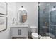 Bright bathroom featuring a marble vanity, modern lighting, a glass shower with blue tile, and neutral décor at 948 Buffalo Ridge Rd, Castle Pines, CO 80108