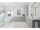 Luxurious main bathroom featuring dual vanities, a standalone tub, and marble countertops, perfect for relaxation at 948 Buffalo Ridge Rd, Castle Pines, CO 80108