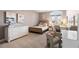 Cozy bedroom with neutral decor features a woven bed frame, modern art, and a comfortable desk area at 948 Buffalo Ridge Rd, Castle Pines, CO 80108