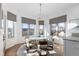 Bright and airy dining area with hardwood floors, a modern chandelier, and large windows at 948 Buffalo Ridge Rd, Castle Pines, CO 80108