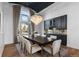 Elegant dining room with a large window, statement chandelier and views to the front yard at 948 Buffalo Ridge Rd, Castle Pines, CO 80108