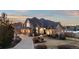 Stunning front exterior with manicured landscaping, a grand entrance, and a circular driveway at 948 Buffalo Ridge Rd, Castle Pines, CO 80108